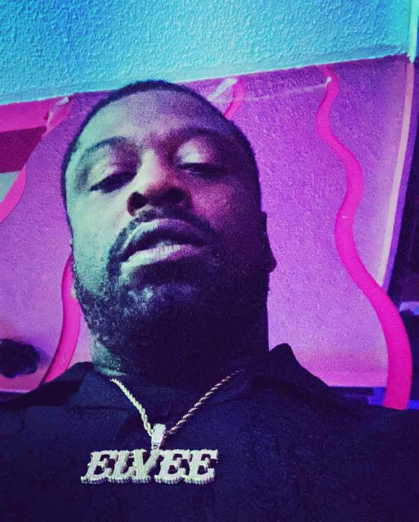 El Vee A local rapper and producer posing in front of the camera for a selfie.