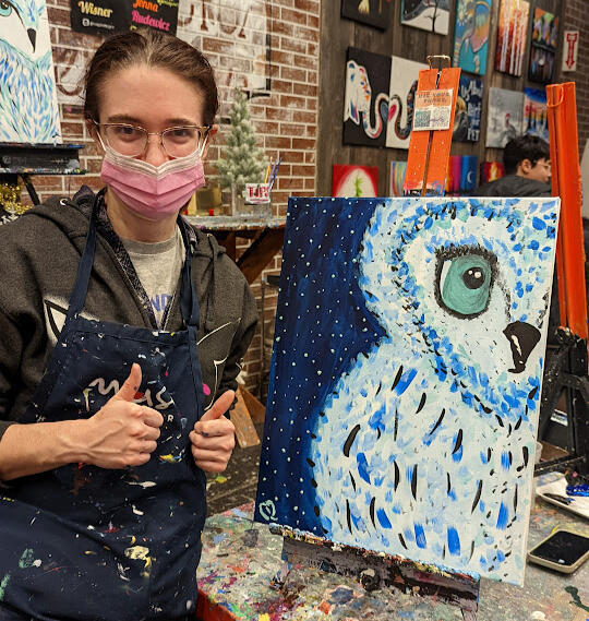 Caitlin Duffy A local artist poses in front of her work at an art studio.